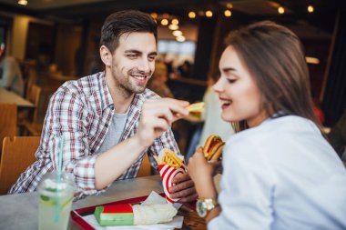 Genç çift fast food Restoran, adam kadını patates besleme eğleniyor