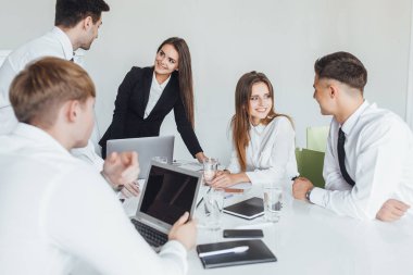 Genç ve başarılı iş ekibi modern konferans odasında iş meselelerini çözüyor.