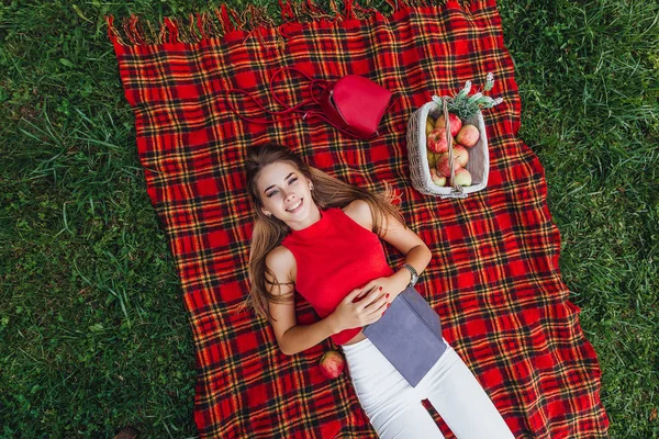 elevated view of blonde woman at picnic in garden