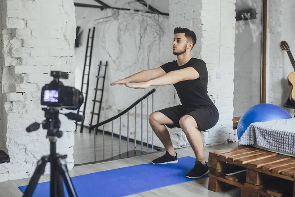 fitness blogger recording video of how to properly squat during sports