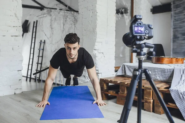 fitness blogger recording video for blog and showing how to properly spin on floor