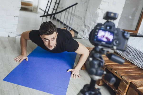 fitness blogger recording video for blog and showing how to properly spin on floor in loft style room