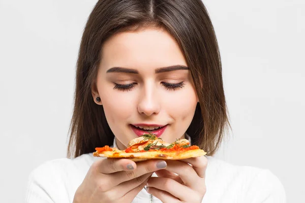 pretty woman eating slice of pizza isolated on white background