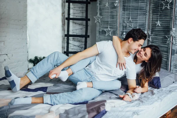 Young Couple Hugging Home Smiling Together — Stock Photo, Image