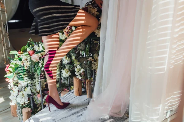 female long legs in purple shoes, selective focus