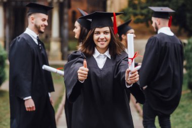 Yüksek lisans mezunları arka arkaya durup parmağını yukarı çeviriyor
