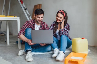Young smiling couple renovating and remodeling new apartment