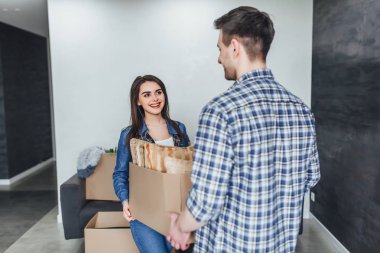 Bir şeyleri açarken yeni evde eğlenen aile 