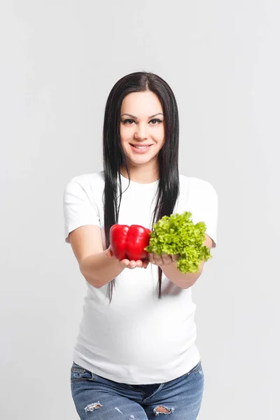 Happy pregnant woman with natural food isolated on white background