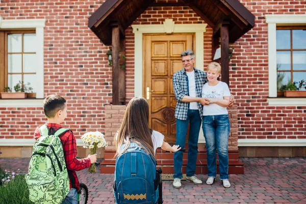 Brother Sister Rushing Meet Visiting Grandparents Home — Stock Photo, Image