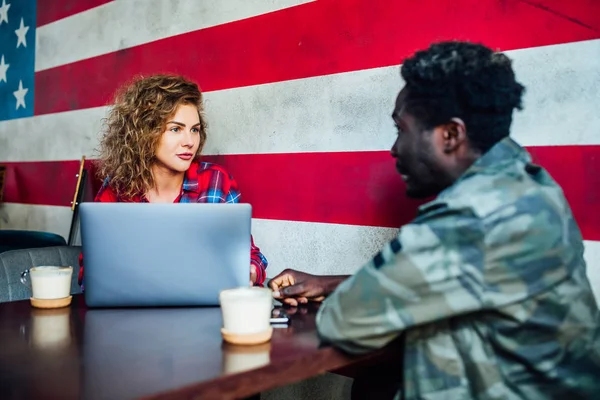 woman resting in bar with man, talking, laughing, eating fast food