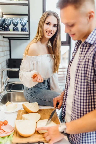 Young beautiful couple cooking at kitchen, selective focus