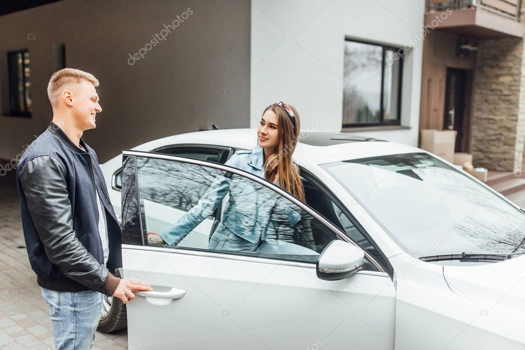 Couple near new white car, selective focus