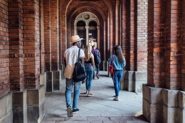 Tam lenth. Başarılı öğrencilerin üniversiteye yakın sınıflara yürüme portresi, geri görünüm.