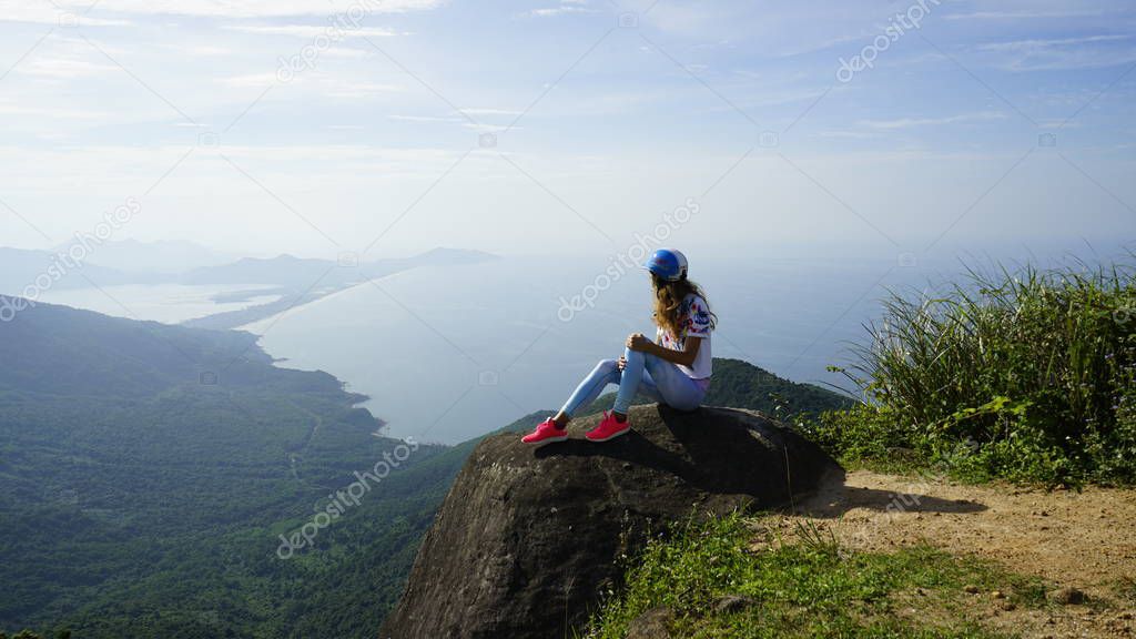 Da Nang Vietnam Asia travel vacation. Women looking at view on famous travel destination. Beautiful young lady wearing fancy outfit on holidays. Amazing view of sea and mountains in DANANG,Asia.