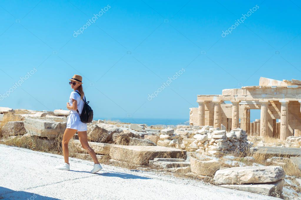 a young girl walks on ancient Greek Acropolis