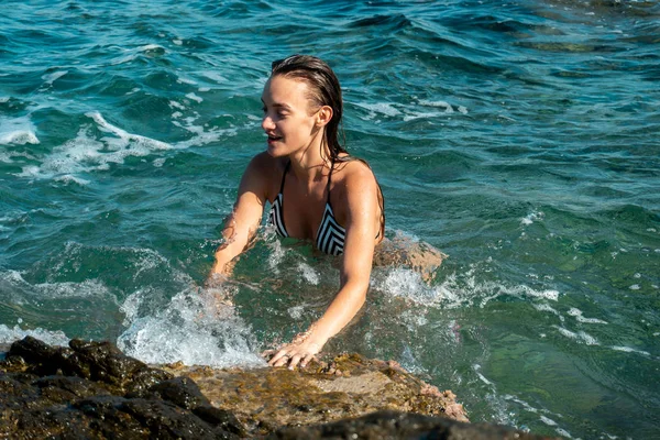 Young girl in the clear blue sea — Stock Photo, Image