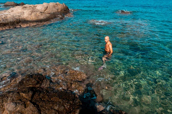 Handsome man on the marine rocky shore — Stock Photo, Image