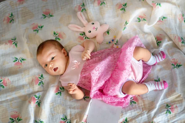 Adorable newborn girl in pink dress — Stock Photo, Image