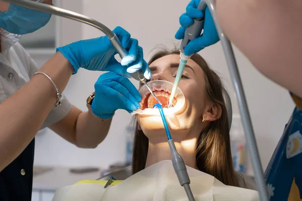 Dentysta i asystent leczą zęby pacjenta — Zdjęcie stockowe