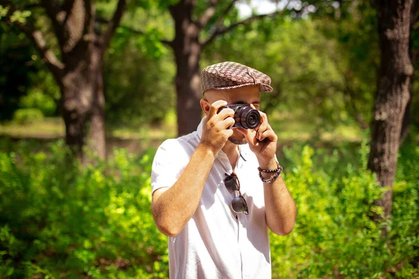 Giovane ragazzo scatta foto sulla macchina fotografica al parco verde — Foto Stock