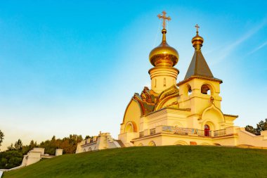 St. Seraphim Tapınağı Sarov Habarovsk şehir içinde güzel manzara günbatımı sırasında. Güzel bir yeşil çim ön planda. Dini mimari, binalar ve gelenekleri. Rusya.
