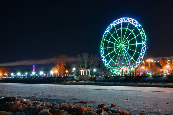 View of the city of Khabarovsk from the Amur river. Ferris wheel.