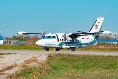 KHABAROVSK, RUSSIA - SEP 29, 2018: Let Kunovice L410 RA-67036 Khabarovsk Avia airline is flying from the runway of Khabarovsk international airport clipart