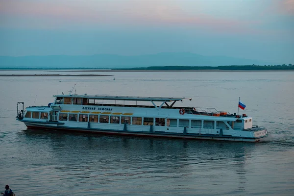 Khabarovsk, Rusia - 17 de mayo de 2019: Puesta de sol en el terraplén del río Amur. Buque de pasajeros en el río Amur al atardecer . —  Fotos de Stock