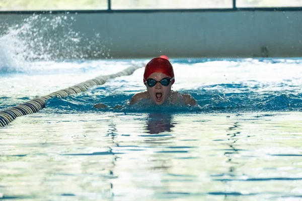 Khabarovsk, Rusia - 19 de mayo de 2019: niños nadando Mariposa. Piscina cubierta con agua azul clara . —  Fotos de Stock