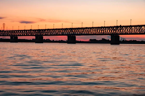 Bridge over the Amur river at sunset. Russia. Khabarovsk. Photo from the middle of the river. — Stock Photo, Image