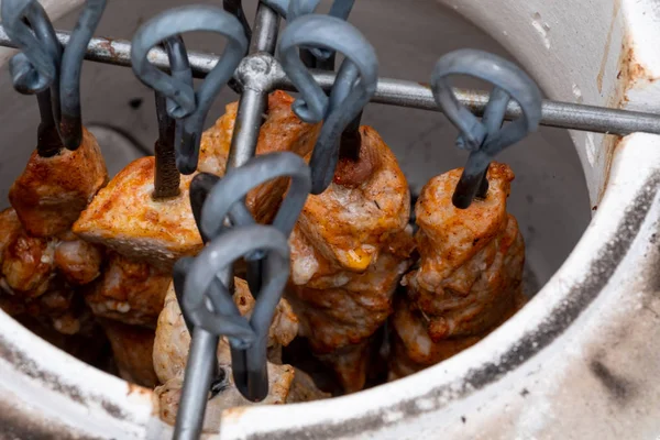 Tandoor 'da şişler. Tandoor 'da et kebabı pişirmek.