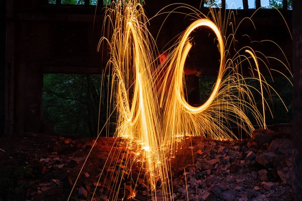 Drawing light at night in an old abandoned building, splashes of light and sparks. Freezelight. — Stock Photo, Image