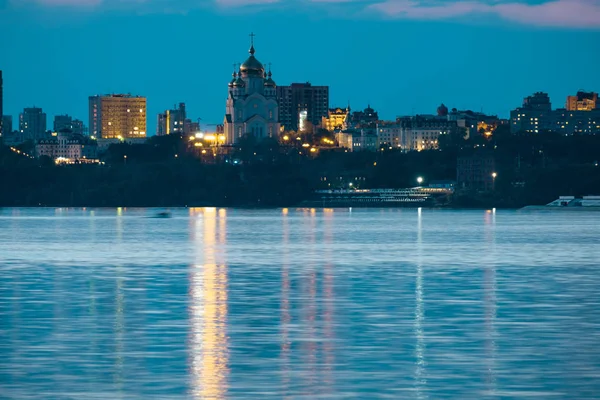 Nachtaufnahme der Stadt Chabarowsk vom Amur aus. Blauer Nachthimmel. Die nächtliche Stadt ist hell erleuchtet mit Laternen. — Stockfoto