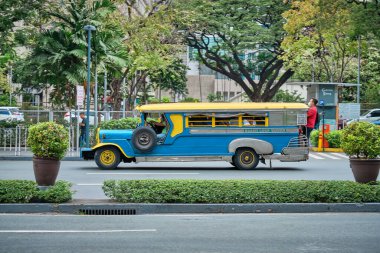 Manila, Philippines - Feb 02, 2020: Jeepneys on the roads of Manila. Former American military jeeps converted to public transport clipart