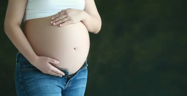 Tummy of pregnancy woman with hands hold — Stock Photo, Image