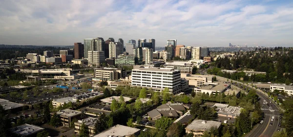 The bustling city of Bellevue Washington in early morning light with Seattle peaking out far in the background