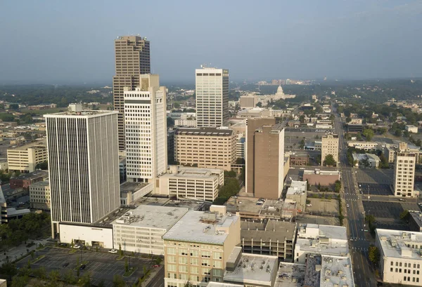 A Square aerial composition of downtown Little Rock buildings with the State Capitol Building background