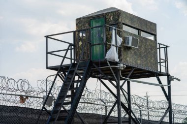 Metal bir çerçeve üzerinde askıya camo kulübe verir Muhafızlar mahkumlar izlemek için bir bakış açısı