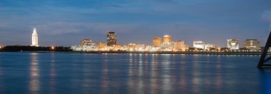 Night Falls on the Mississippi River Showing State Capital Building Baton Rouge clipart