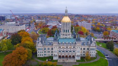 An aerial view focusing on the Connecticut State House with blazing fall color in the trees around Hartford clipart