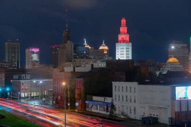 The buildings are illuminated before sunrise in the urban core of Buffalo New York clipart