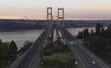 Traffic makes way across the bridge over Puget Sound in Washington State between Tacoma and Gig Harbor clipart