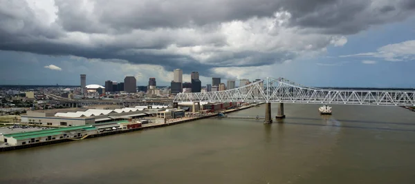 The Mississippi River flows softly past the downtown city skyline waterfront of New Orleans Louisiana