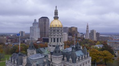 Downtown buildings under a dark sky at the Connecticut state capitol building in Hartford clipart