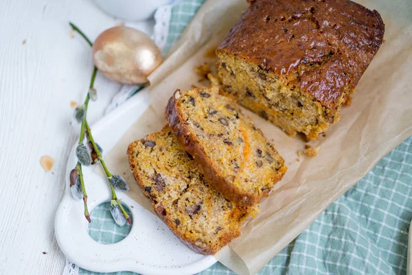 Carrot loaf cake with shiny glaze and nuts on white wooden background close up selective focus — Stock Photo, Image