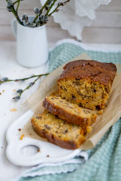 Carrot loaf cake with shiny glaze and nuts on white wooden background close up selective focus — Stock Photo, Image