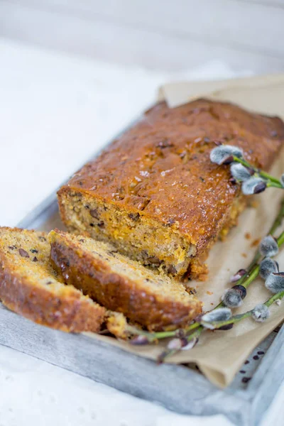 Carrot loaf cake with shiny glaze and nuts on white wooden background close up selective focus — Stock Photo, Image