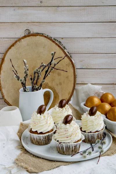 Carrot Easter cupcakr with chocolate egg on top and whipped cream frosting close up seective focus — Stock Photo, Image