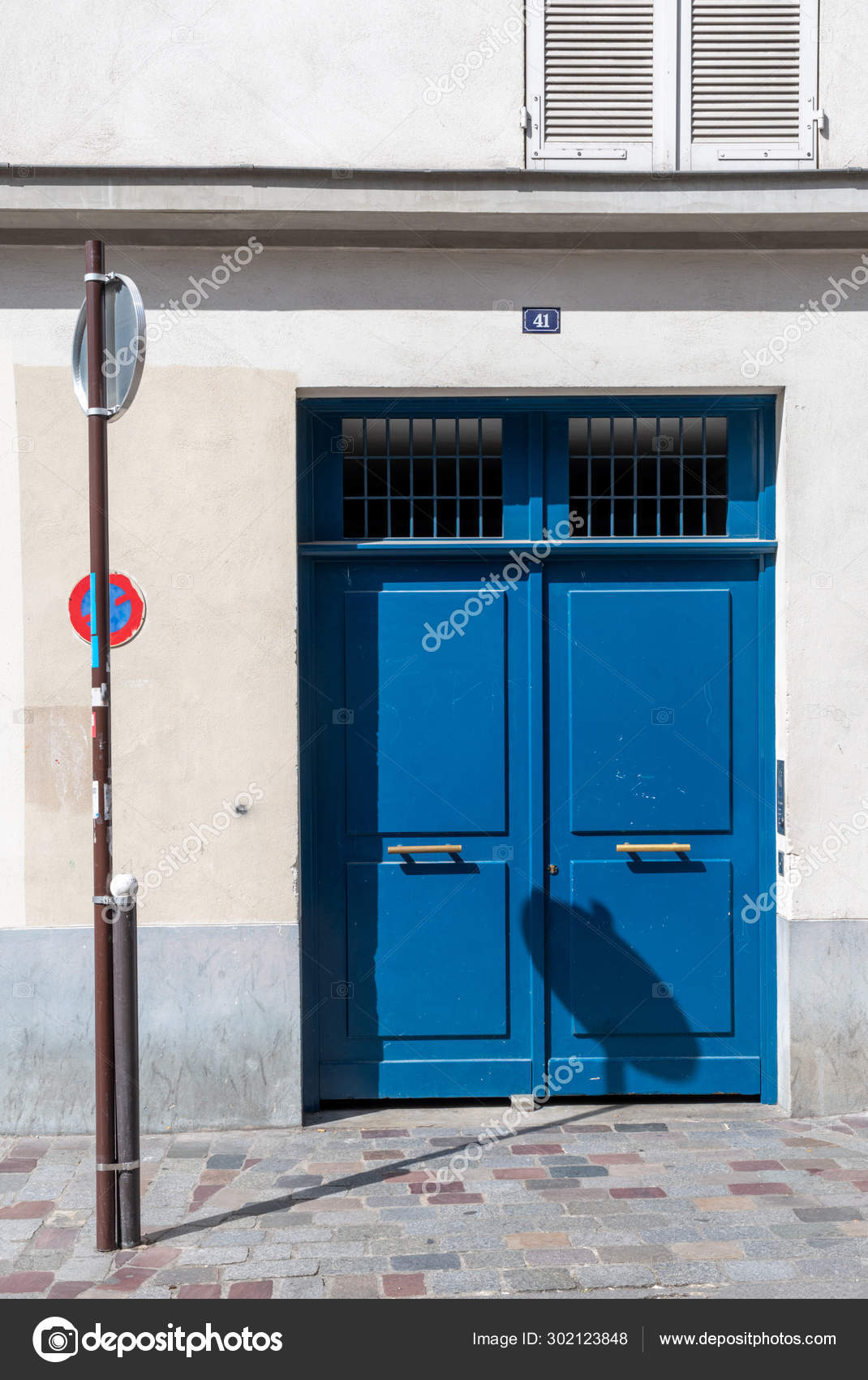 Shadow Road Sign Bright Blue Painted Door White Building